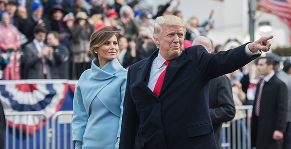President Trump points at the crowd as he walks pass the inaugural parade reviewing stand in the 58th Presidential Inaugural parade in Washington D.C., January 20, 2017. U.S. Armed Forces personnel provide ceremonial support to the 58th Presidential Inaugural during the Inaugural period. This support comprises musical units, marching elements, color guards, salute batteries, and honor cordons, which render appropriate ceremonial honors to the Commander-In-Chief. (U.S. Army photo by Pvt. Gabriel Silva)